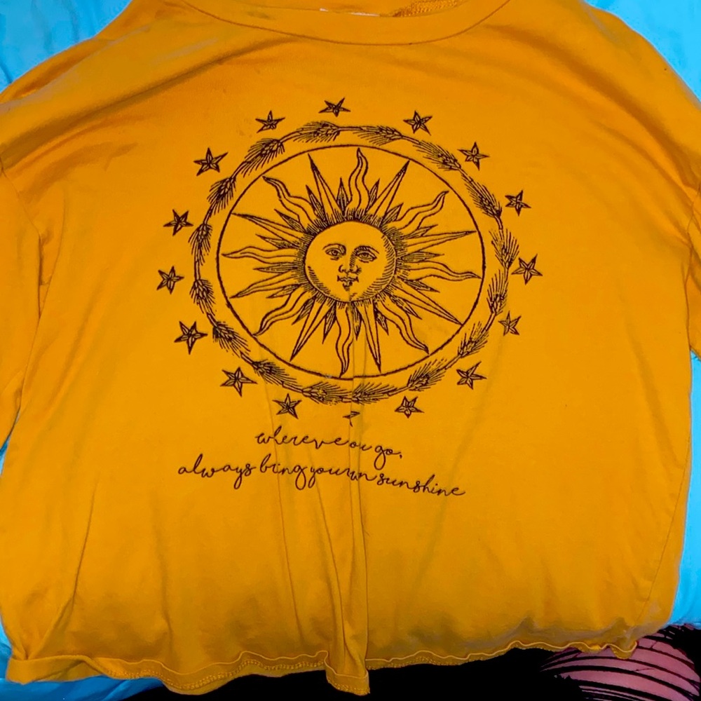 This is a yellow long sleeve shirt made for kids size medium